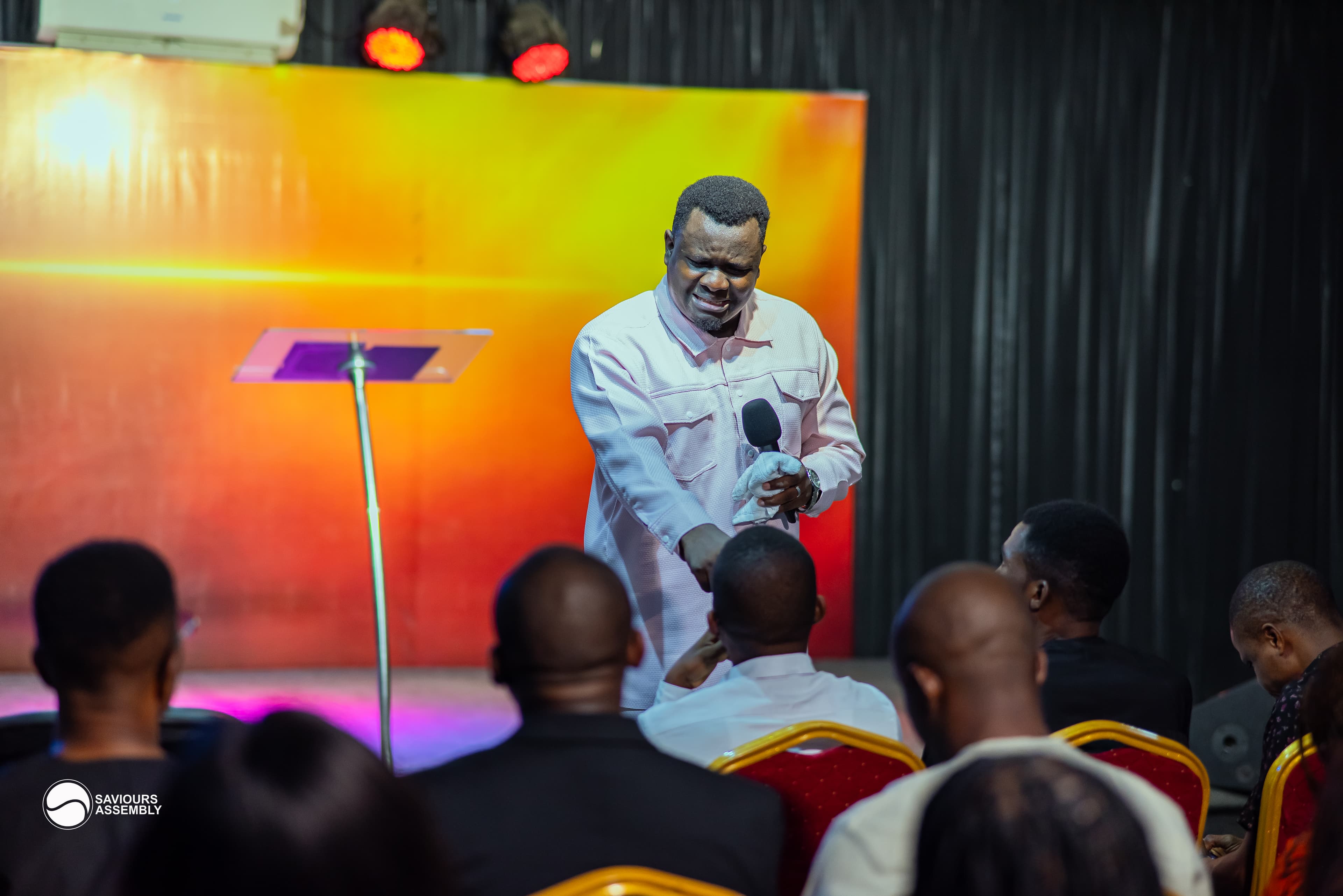 Pastor Henry ministering during Sunday worship